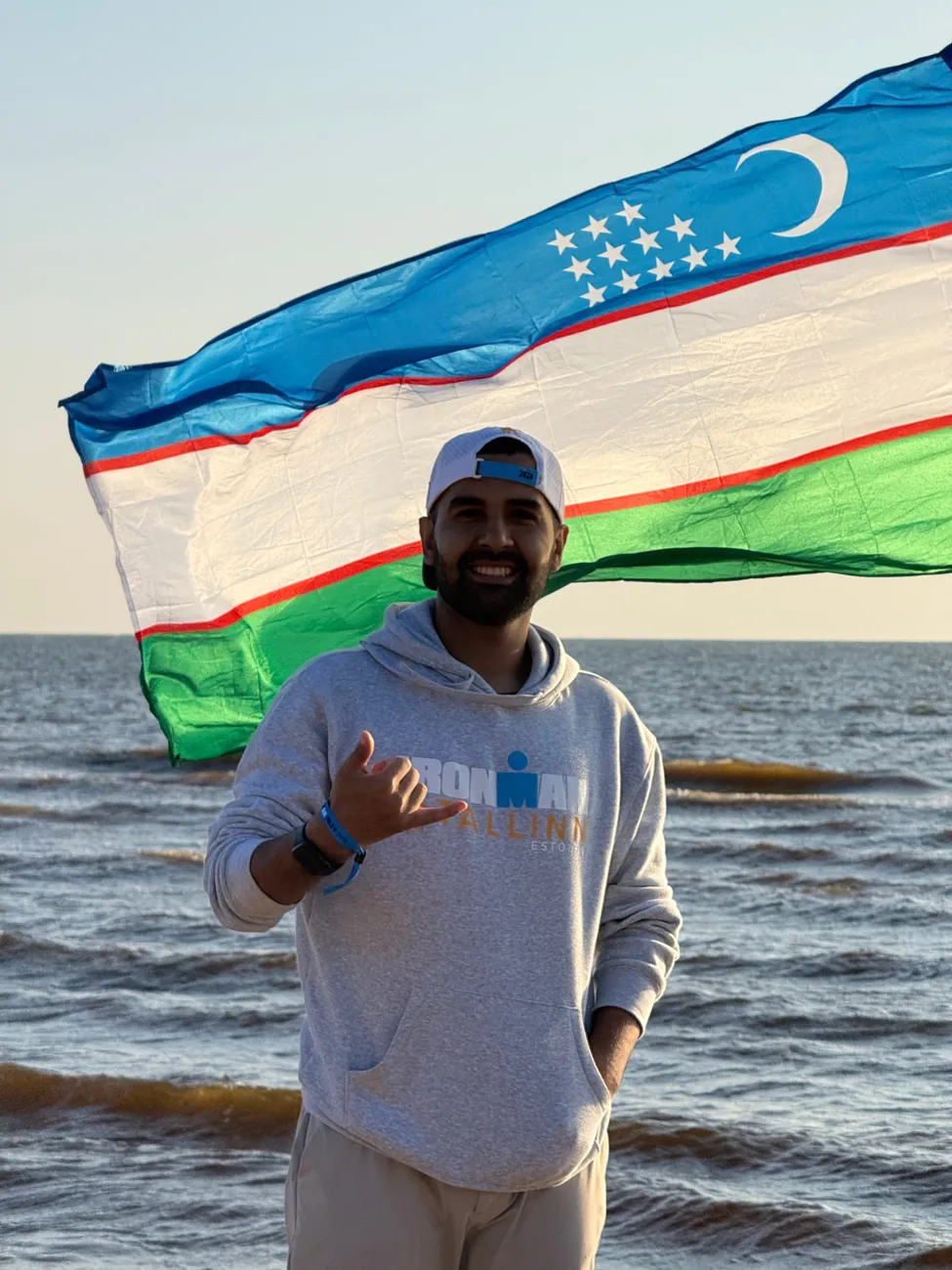 With the flag of Uzbekistan on the Baltic coast